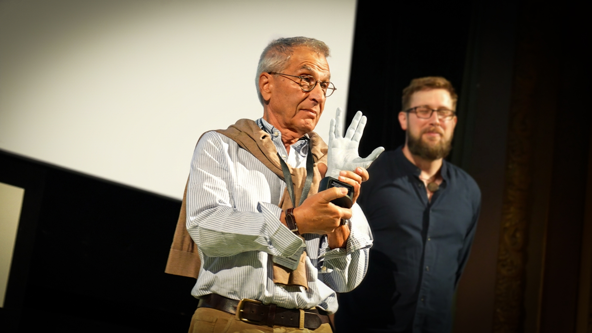 Nicholas Meyer with the 3D printed hand-shaped award making the Vulcan salute at the Lucerna cinema